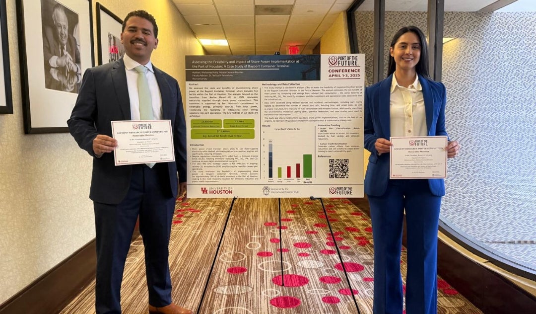 Rice University Master of Energy Economics students holding awards in front of their research poster at the Port of the Future conference