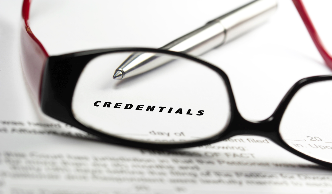 Glasses on top of document, showing word "CREDENTIALS"; Rice University Master of Global Affairs