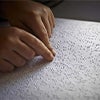Hands reading braille