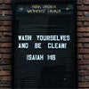 Sign reading "Wash Yourselves and Be Clean"